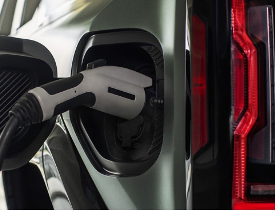 Close up of charging port with charger plugged in on a GMC Hummer EV SUV - GMC of Billings in Billings MT